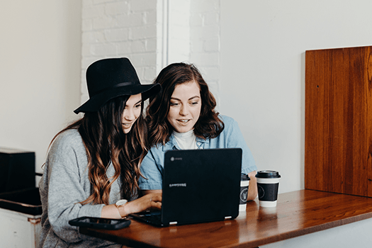 Junior level: Two girls working on a laptop together